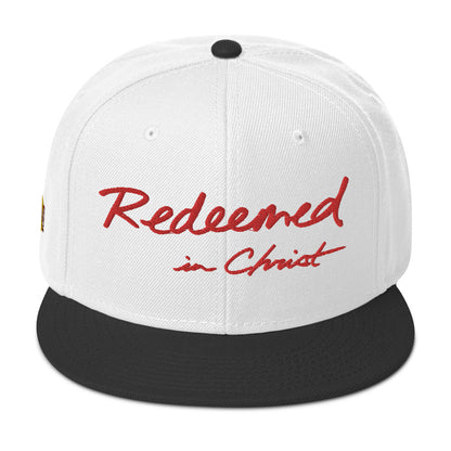 REDEEMED IN CHRIST (red embroidery) — Unisex Snapback Hat