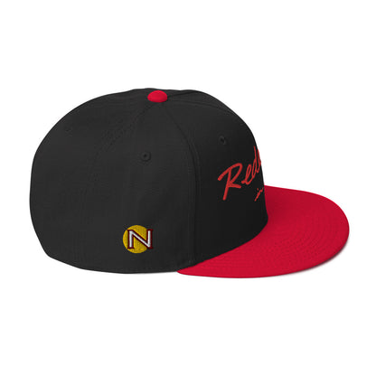 REDEEMED IN CHRIST (red embroidery) — Unisex Snapback Hat