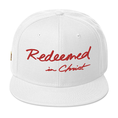 REDEEMED IN CHRIST (red embroidery) — Unisex Snapback Hat